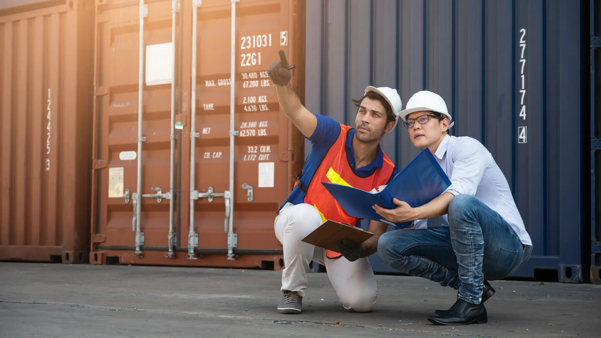 Logistics operators at a Spanish port reviewing import containers from China